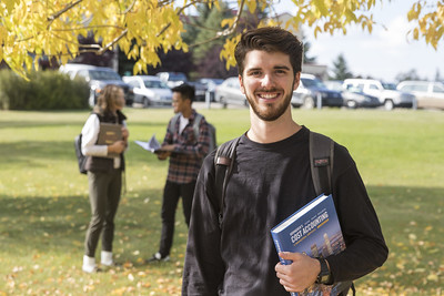 student holding textbook